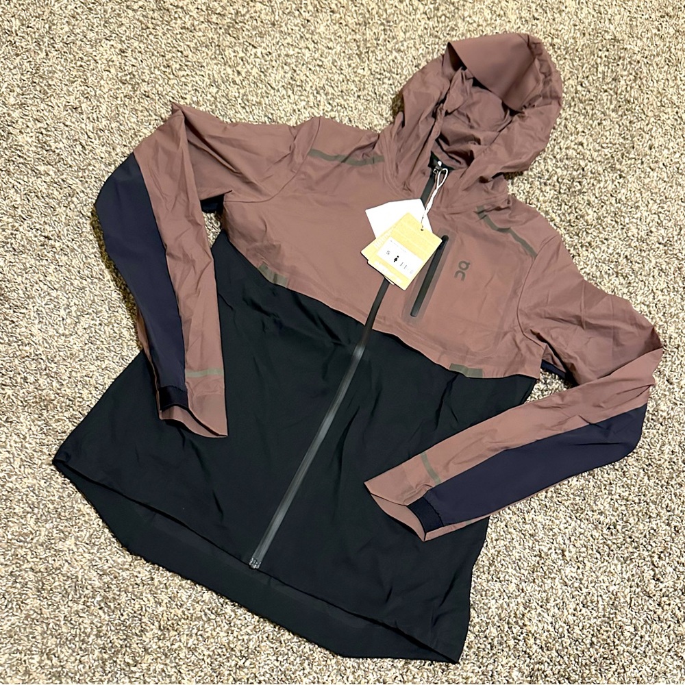 on running women’s weather jacket color is grape and black size is a small